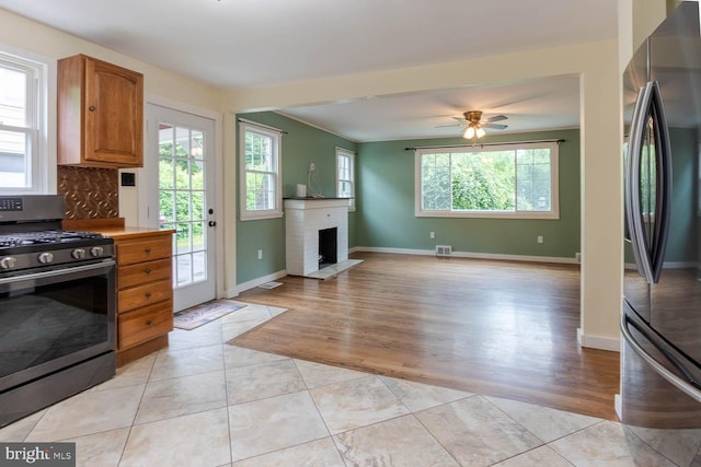 1724 E Branch Rd, State College, PA 16801 - kitchen with appliances with stainless steel finishes, a ceiling fan, a brick fireplace, and baseboards