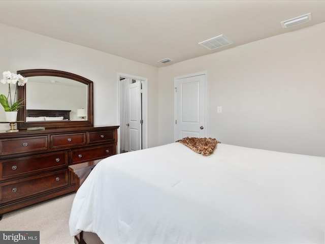 bedroom featuring light colored carpet and visible vents