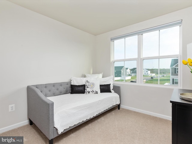 carpeted bedroom featuring baseboards