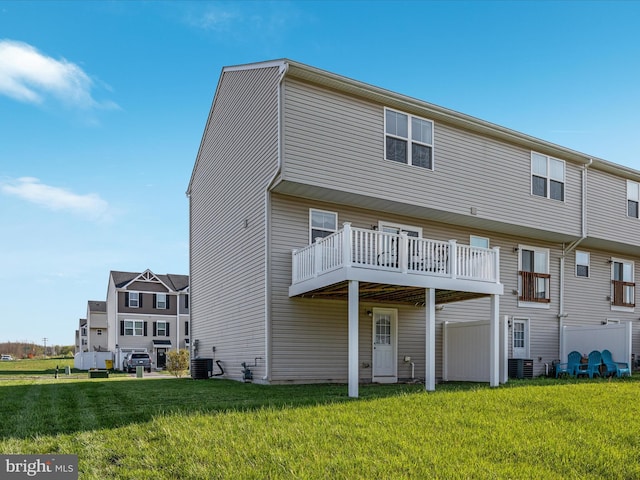 rear view of property with a yard and cooling unit