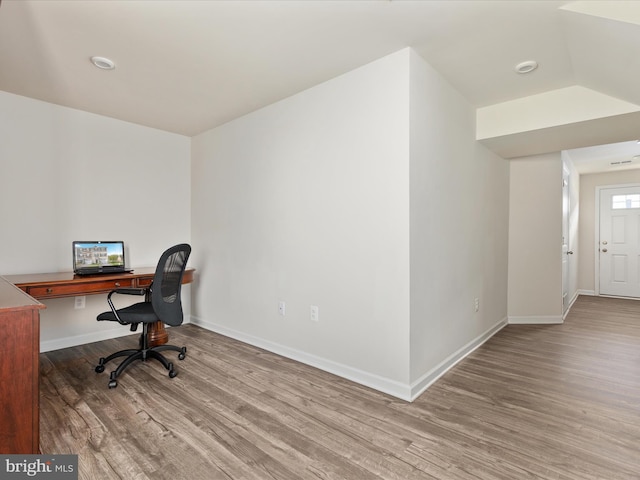 office space featuring baseboards and wood finished floors