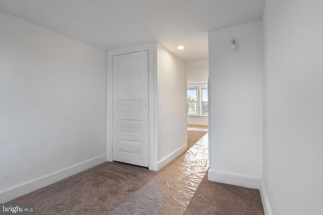 hallway with recessed lighting, baseboards, and carpet