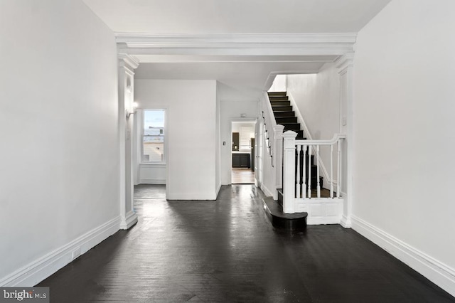 interior space featuring baseboards, stairs, and dark wood-style floors