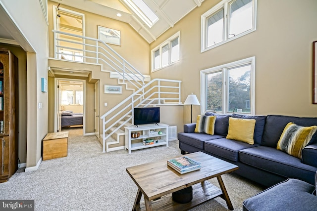 22 Harbor Rd, Rehoboth Beach, DE 19971 - carpeted living area featuring stairway and a towering ceiling