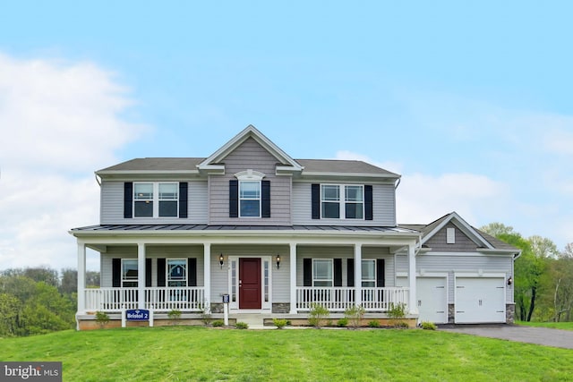 colonial inspired home featuring a porch, a standing seam roof, driveway, and a front yard