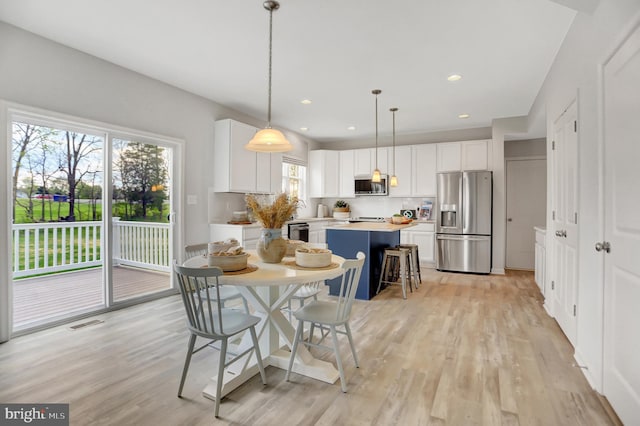 dining room featuring recessed lighting, visible vents, and light wood finished floors