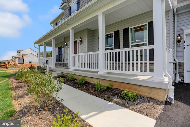 view of exterior entry featuring a porch