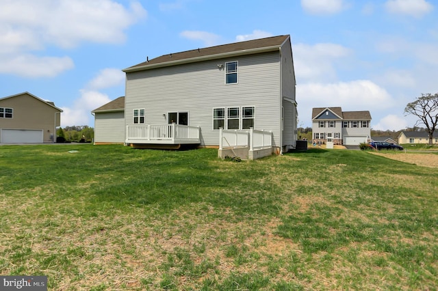 back of house with a lawn, a deck, and central air condition unit