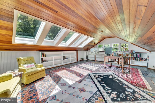 interior space with baseboard heating, wood ceiling, and vaulted ceiling with skylight