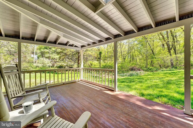wooden deck featuring a yard