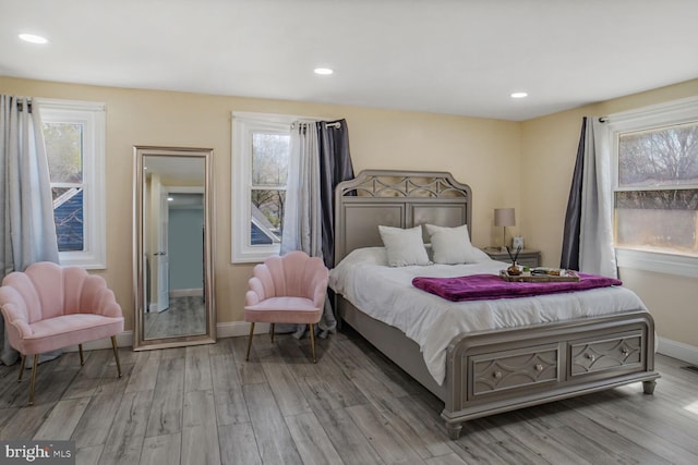 bedroom with baseboards, recessed lighting, and wood finished floors