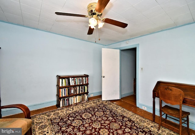 sitting room featuring ceiling fan and wood finished floors
