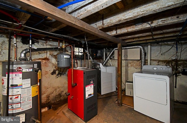 unfinished basement featuring a heating unit, gas water heater, and washing machine and dryer
