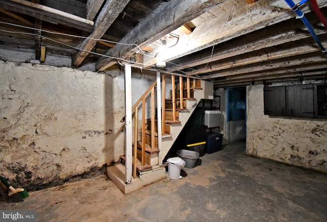 unfinished below grade area featuring stairs