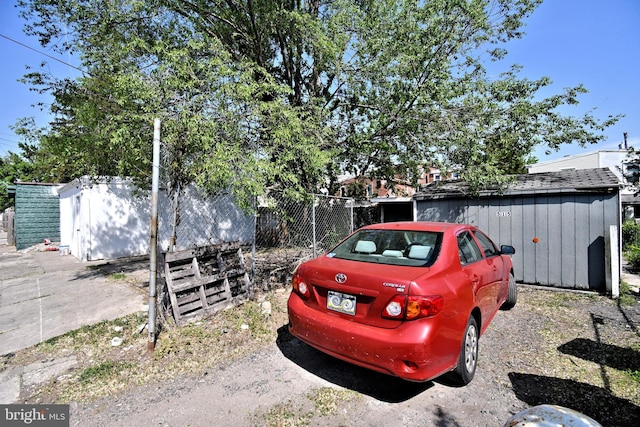 exterior space with fence and a shed