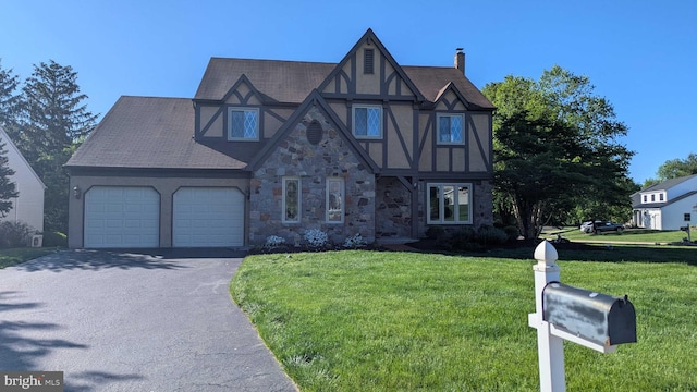 4 Sunflower Ct, Newtown, PA 18940 - tudor home featuring asphalt driveway, stone siding, a garage, a front yard, and stucco siding