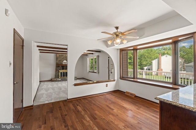 4 Sunflower Ct, Newtown, PA 18940 - unfurnished dining area featuring a ceiling fan, hardwood / wood-style flooring, a fireplace, and baseboards