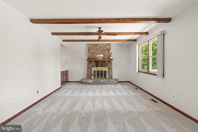 4 Sunflower Ct, Newtown, PA 18940 - unfurnished living room featuring a stone fireplace, baseboards, carpet floors, a ceiling fan, and beamed ceiling
