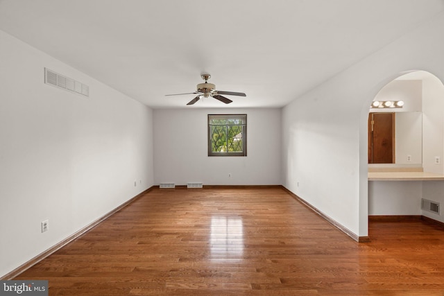 4 Sunflower Ct, Newtown, PA 18940 - unfurnished room with a ceiling fan, arched walkways, wood finished floors, and baseboards