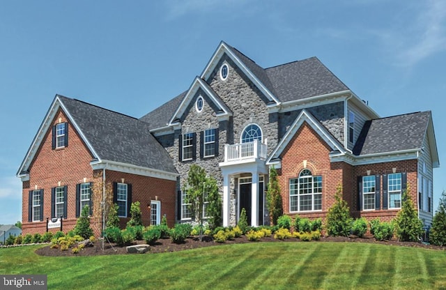 17905 Queen Anne Rd, Upper Marlboro, MD 20774 - view of front of house featuring a front yard, brick siding, a balcony, a shingled roof, and stone siding