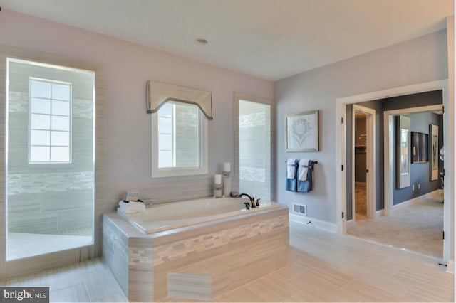 17905 Queen Anne Rd, Upper Marlboro, MD 20774 - full bath featuring baseboards, plenty of natural light, a garden tub, and visible vents