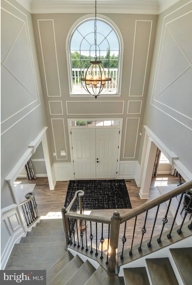 17905 Queen Anne Rd, Upper Marlboro, MD 20774 - foyer featuring an inviting chandelier, wood finished floors, stairway, and a decorative wall