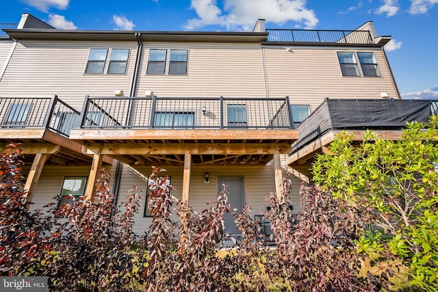 rear view of property with a wooden deck