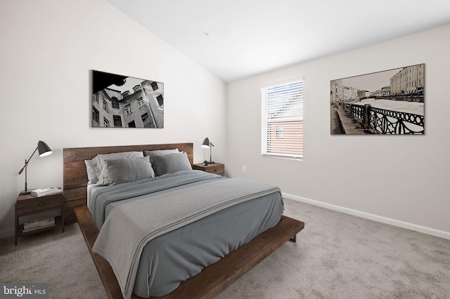 bedroom featuring carpet floors, baseboards, and lofted ceiling