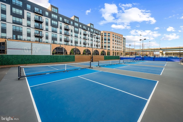 view of sport court featuring fence
