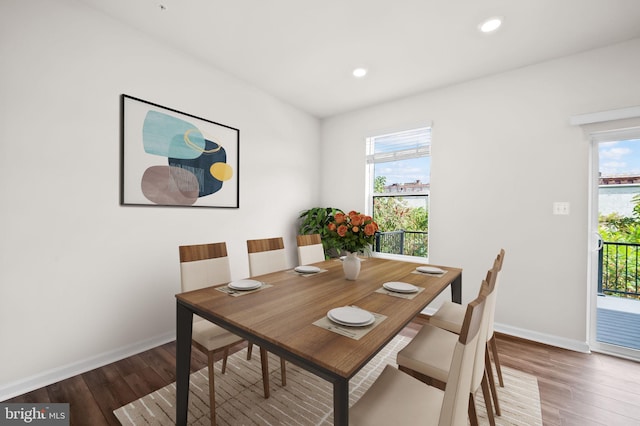 dining room featuring baseboards, recessed lighting, and wood finished floors