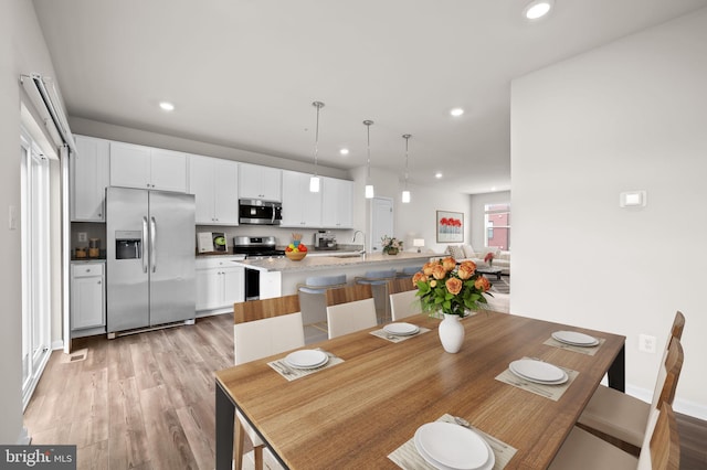 dining area with recessed lighting, light wood finished floors, and visible vents