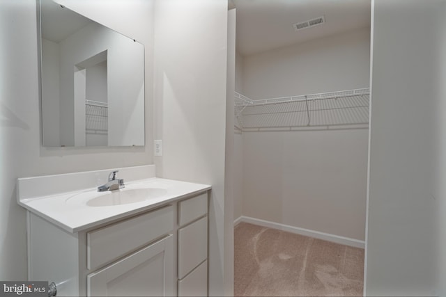 230 Rhea Dr, Martinsburg, WV 25403 - bathroom featuring a spacious closet, baseboards, vanity, and visible vents