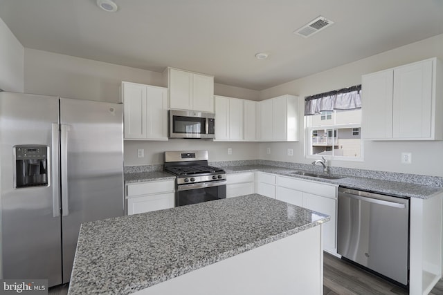 230 Rhea Dr, Martinsburg, WV 25403 - kitchen with light stone countertops, a sink, stainless steel appliances, white cabinetry, and visible vents