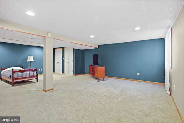 finished below grade area with carpet flooring, a paneled ceiling, recessed lighting, baseboards, and visible vents