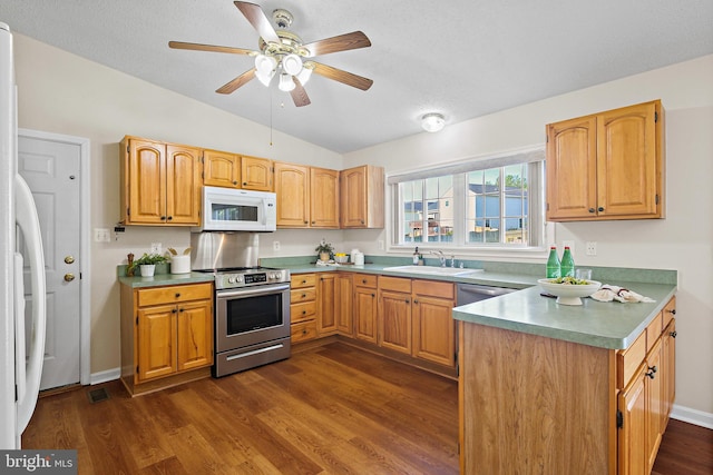 kitchen with stainless steel electric range, white microwave, a sink, lofted ceiling, and dark wood-type flooring