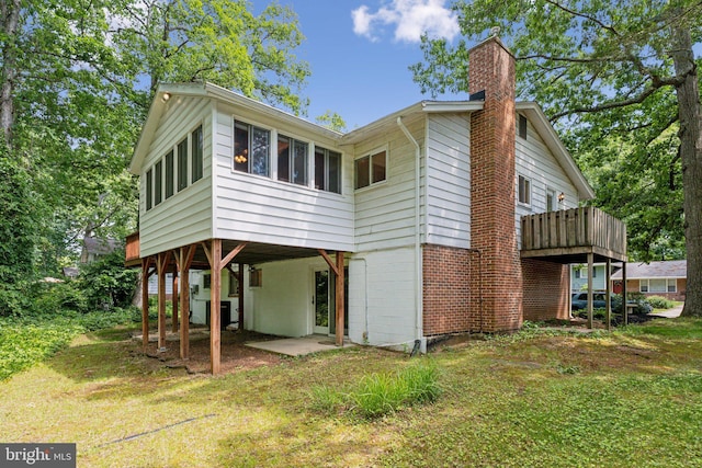 1406 Catlyn Pl, Annapolis, MD 21401 - rear view of property with a carport, a chimney, a lawn, and a wooden deck