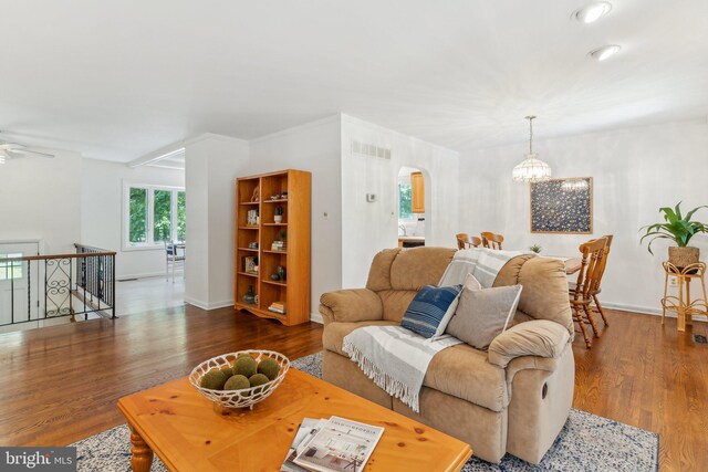 1406 Catlyn Pl, Annapolis, MD 21401 - living room featuring arched walkways, wood finished floors, baseboards, and a chandelier