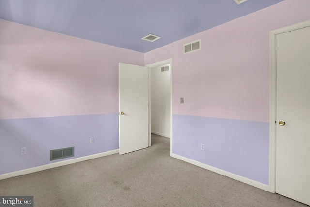 carpeted empty room with baseboards and visible vents