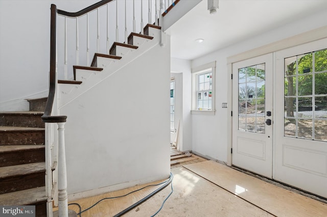 entryway featuring stairway and french doors
