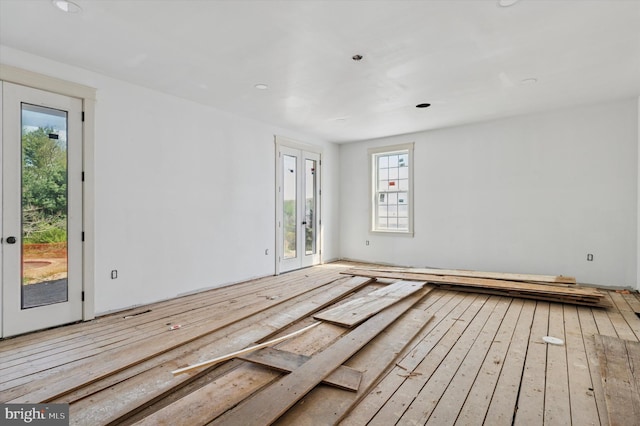 spare room with wood-type flooring, recessed lighting, and a healthy amount of sunlight