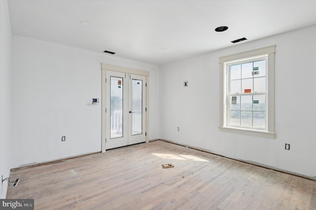 empty room featuring visible vents and light wood finished floors