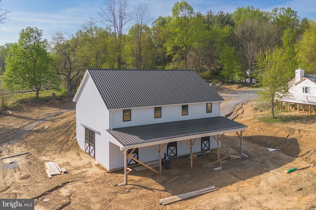 rear view of property with metal roof