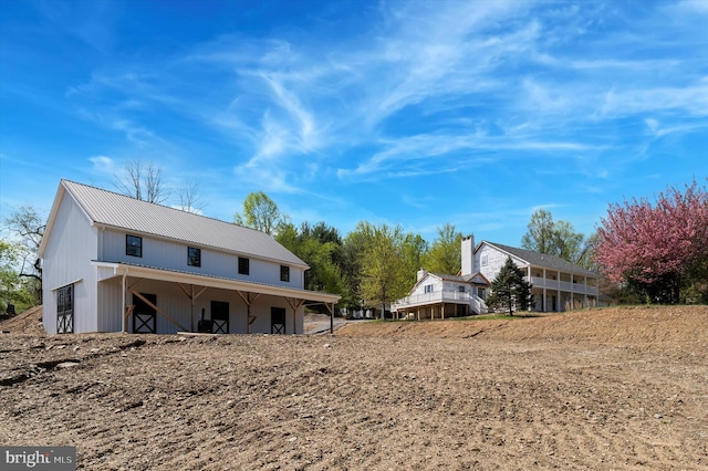 rear view of property featuring metal roof