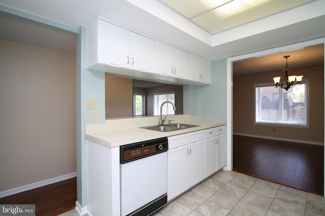 kitchen with light countertops, a notable chandelier, a sink, and dishwasher