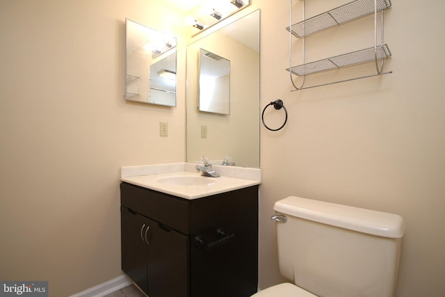 half bathroom featuring toilet and vanity