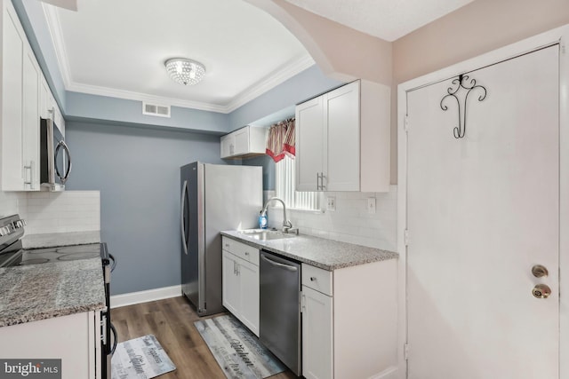 4927 Oxford Ct, Bensalem, PA 19020 - kitchen with white cabinets, backsplash, appliances with stainless steel finishes, and visible vents