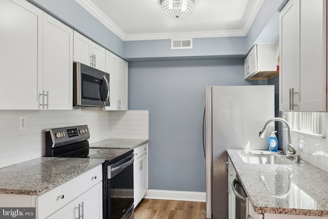 4927 Oxford Ct, Bensalem, PA 19020 - kitchen with a sink, appliances with stainless steel finishes, ornamental molding, and visible vents