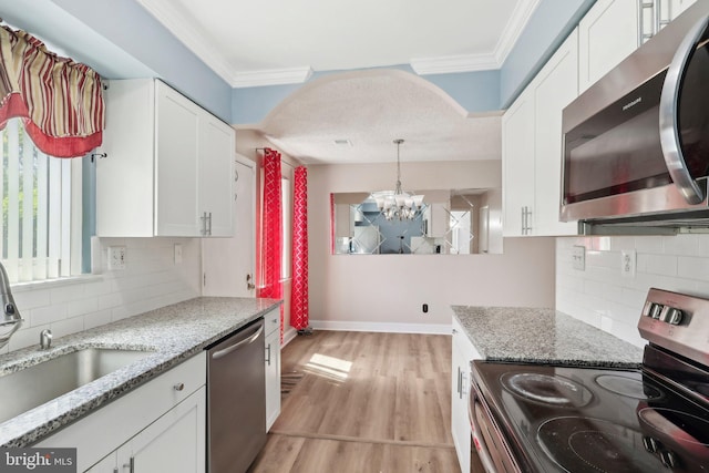 4927 Oxford Ct, Bensalem, PA 19020 - kitchen with ornamental molding, a sink, appliances with stainless steel finishes, and a chandelier