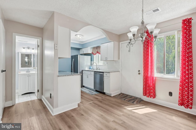 4927 Oxford Ct, Bensalem, PA 19020 - kitchen with visible vents, a sink, a notable chandelier, light wood-style floors, and stainless steel appliances