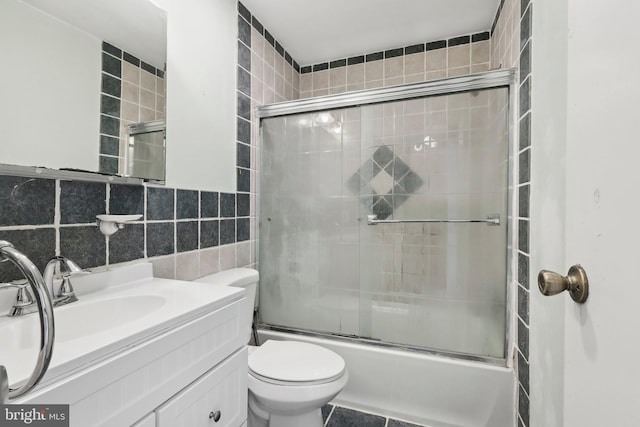 4927 Oxford Ct, Bensalem, PA 19020 - bathroom featuring toilet, tile walls, combined bath / shower with glass door, and vanity